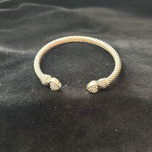 Silver tone twisted look slip on bangle with silver tone hearts at opening